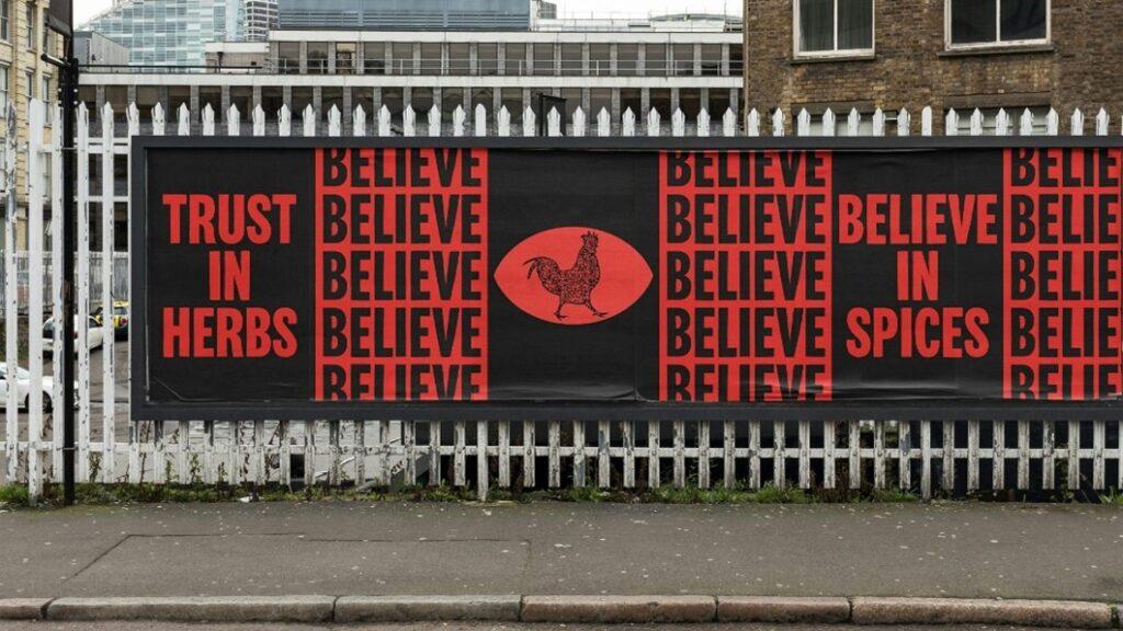 One the KFC adverts. The image shows a poster on the wall with a black background and the words "Believe" and "believe in spices" in bold red.