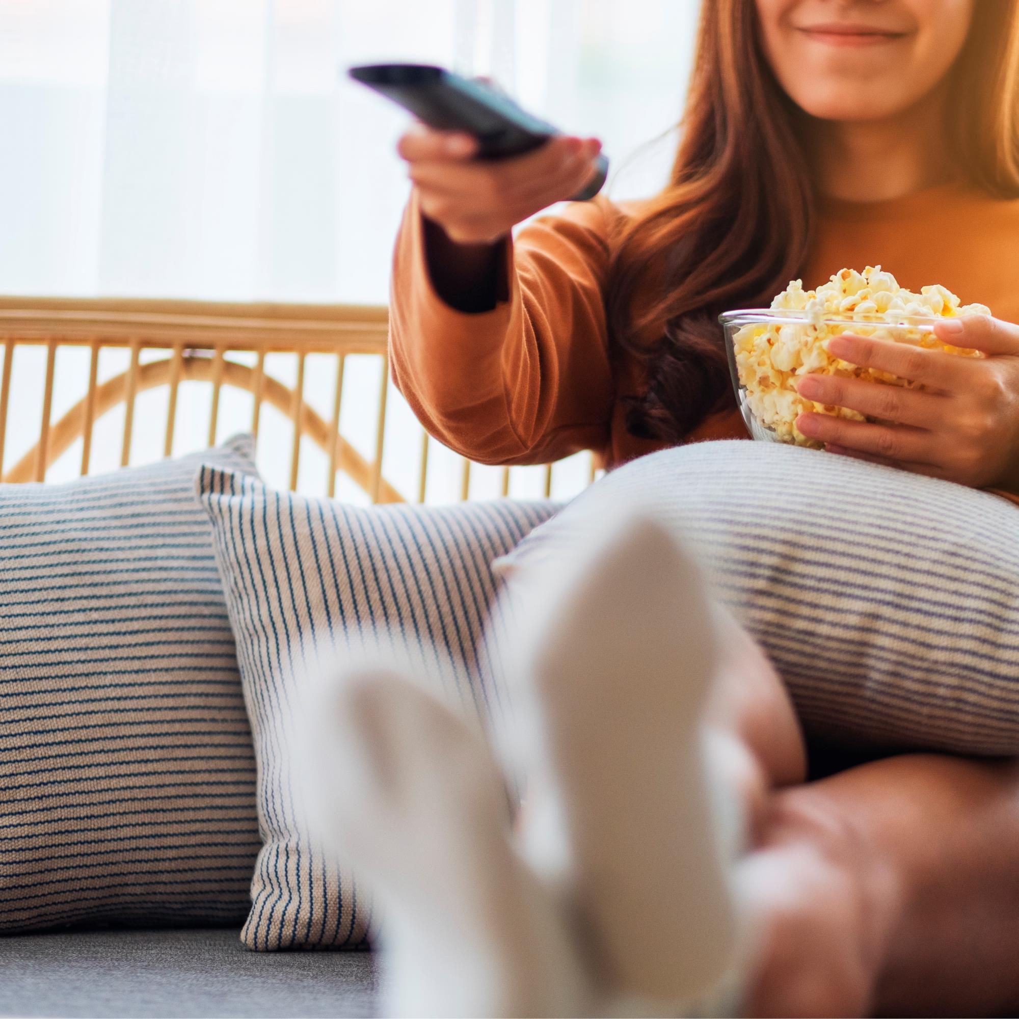 An image of a woman watching Sky TV and being engaged by Sky Adsmart ads.